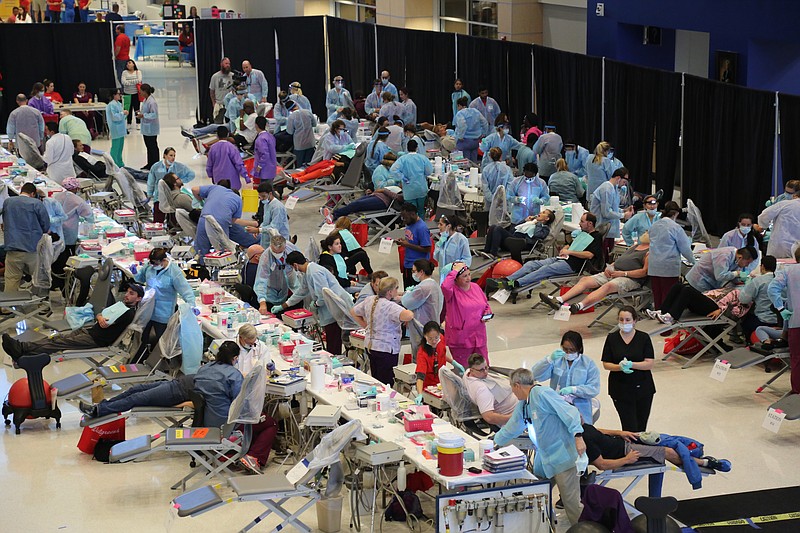 People receive free dental care at a previous Remote Area Medical clinic. RAM will hold a free medical clinic July 8-9 in Athens, Tenn.