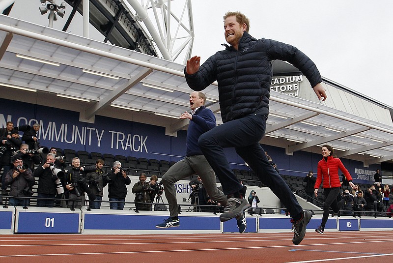 
              FILE - In this file photo dated  Sunday, Feb. 5, 2017, Britain's Prince Harry, centre, leads Prince William, left, and Kate, the Duchess of Cambridge, background right, during a fun relay race, to promote the charity Heads Together, at the Queen Elizabeth II Park in London.  In an interview with Newsweek magazine published Thursday June 22, 2017, Britain’s Prince Harry has suggested that no one in the royal family really wishes to rise to the throne, and that it is duty, rather than desire, that prompts them to continue serving the British people. (AP Photo/Alastair Grant, FILE)
            