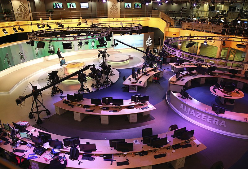 
              FILE - In this Jan. 1, 2015, file photo, staff members of Al-Jazeera International work at the news studio in Doha, Qatar. Kuwait has given Qatar a list of demands from Saudi Arabia and other Arab nations that includes shutting down Al-Jazeera and cutting diplomatic ties to Iran. (AP Photo/Osama Faisal, File)
            