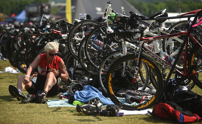 Becky Meagher changes shoes before beginning the running portion of the Waterfront Triathlon Sunday, June 26, 2016.