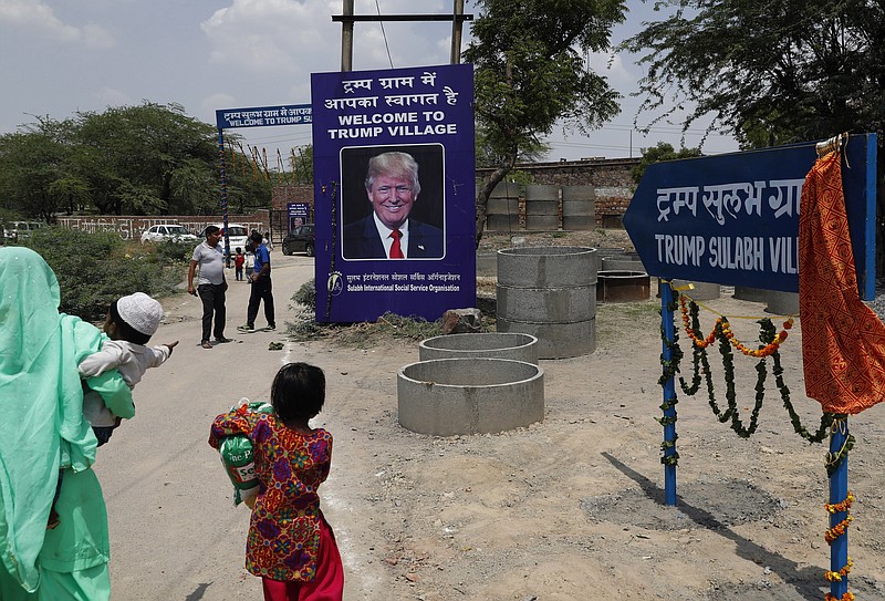 
              A photograph of U.S. President Donald Trump is displayed at the entrance of Trump Sulabh Village in Maroda, India, Friday, June 23, 2017. A toilet charity is leading an effort to rename a tiny, north Indian village after President Donald Trump, saying the gesture is meant to honor relations with the U.S. and draw support for better sanitation in India. (AP Photo/Tsering Topgyal)
            