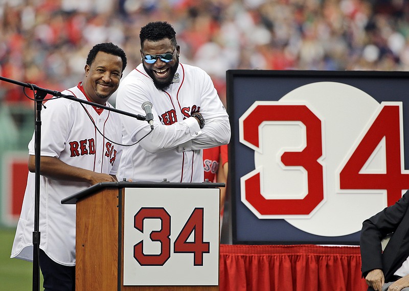 
              Boston Red Sox baseball great David Ortiz, right, laughs with Hall of Fame pitcher Pedro Martinez, Friday, June 23, 2017, at Fenway Park in Boston as the team retired Ortiz's jersey No. 34 worn when he led the franchise to three World Series titles. It is the 11th number retired by the Red Sox. (AP Photo/Elise Amendola)
            