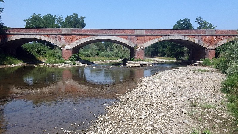 
              Scarce water passes under a bridge on the Po river in Staffarda, Northern Italy, Friday, June 23, 2017. Italy's farm lobby is warning that agricultural production is plummeting nationwide because of prolonged heat and dry weather — and authorities are now rationing water and declaring a state of emergency in some areas. (Rosso/ANSA via AP)
            