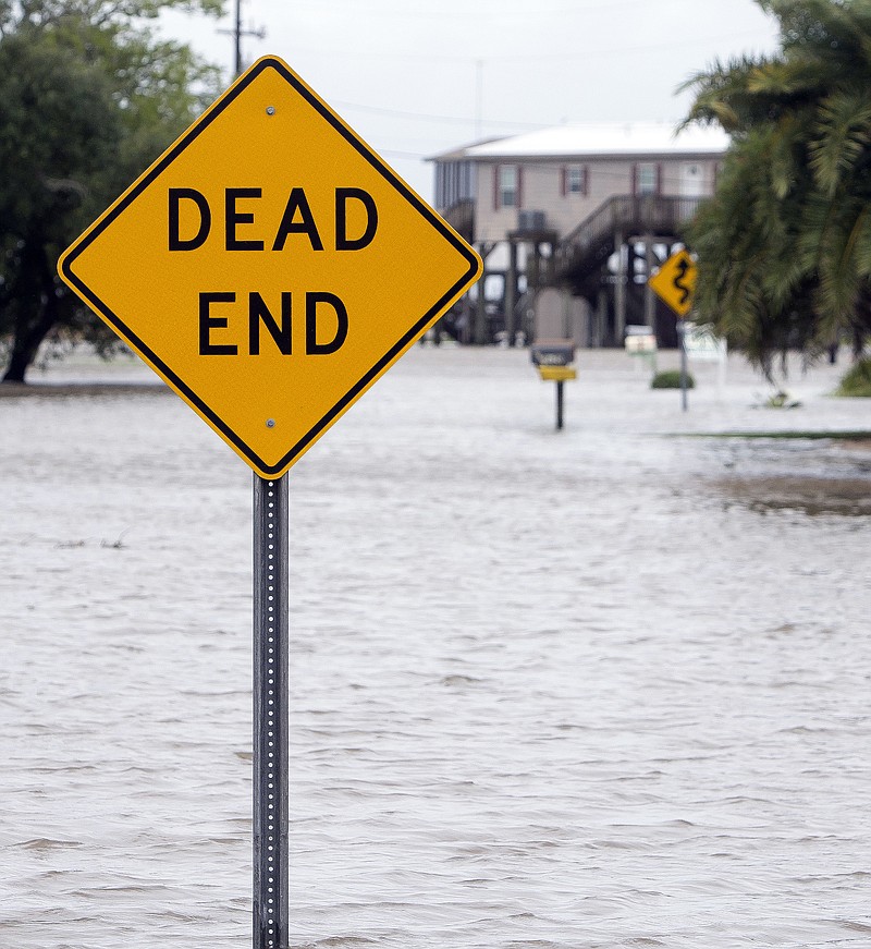 
              Water levels rise after a combination of high tide and the rain from Tropical Storm Cindy in Lake Charles, La., Thursday, June 22, 2017. (Rick Hickman/American Press via AP)
            