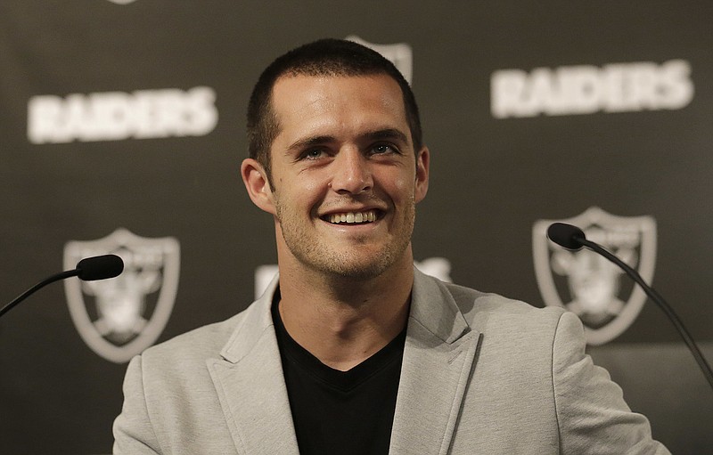 
              Oakland Raiders quarterback Derek Carr smiles while speaking at a news conference in Oakland, Calif., Friday, June 23, 2017. Carr finalized a five-year contract extension that will keep him with the team through the 2022 season. (AP Photo/Jeff Chiu)
            