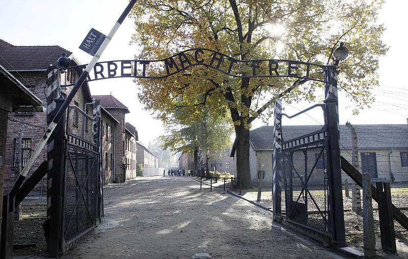 
              FILE - In this Oct. 19, 2012 file photo shows the main gate at the former German death camp of Auschwitz, in Oswiecim, Poland. A leading Polish human rights official, Adam Bodnar, has come under fire for saying the "Polish nation" took part in the implementation of the Holocaust _ a controversial statement in a country that never collaborated with Nazi Germany during World War II. (AP Photo/Czarek Sokolowski, File)
            