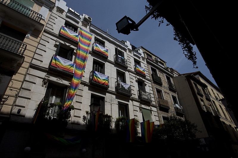 
              In this photo taken on Thursday June 22, 2017, rainbow flags, commonly known as gay pride or LGBT pride flags decorate a building in the Chueca district, a popular area for the gay community in Madrid, Spain. With security ratcheted up owing to the expected arrival of two or three million tourists, Madrid is gearing up to be the world capital of gay pride, a noisy and colorful mixture of vindication for sexual and gender diversity with commercialism and all-night partying. (AP Photo/Paul White)
            