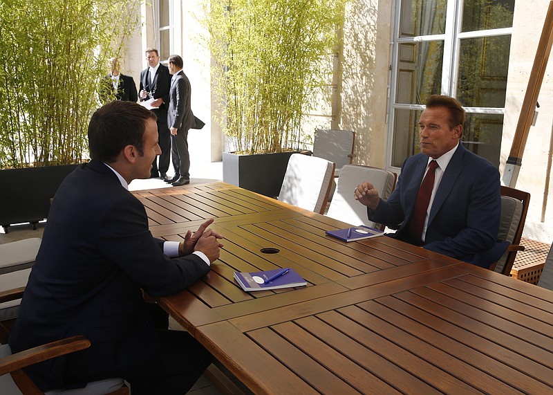 
              French President Emmanuel Macron, left, speaks with former US actor and founder of the R20 climate action group Arnold Schwarzenegger Friday, June 23, 2017 at the Elysee Palace in Paris. (Geoffroy van der Hasselt, Pool via AP)
            