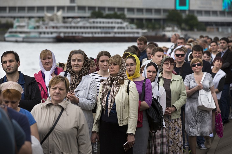 
              In this photo taken on Friday, May 26, 2017, Russian Orthodox believers line up to kiss the relics of Saint Nicholas that were brought from an Italian church where they have lain for 930 years, in the Christ the Savior Cathedral in Moscow, Russia. Over a million people have visited relics of Saint Nicholas, one of the Russian Orthodox Church's most revered figures, since they were brought to Moscow last month. (AP Photo/Alexander Zemlianichenko)
            