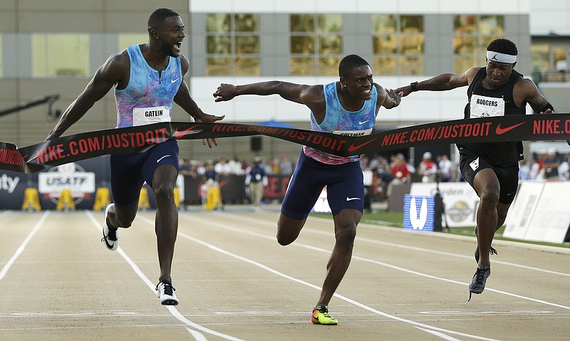 
              Justin Gatlin, left, reacts as he defeats Christian Coleman, center, in the men's 100-meter final at the U.S. Track and Field Championships, Friday, June 23, 2017, in Sacramento, Calif. Mike Rodgers, right, finished sixth. (AP Photo/Rich Pedroncelli)
            