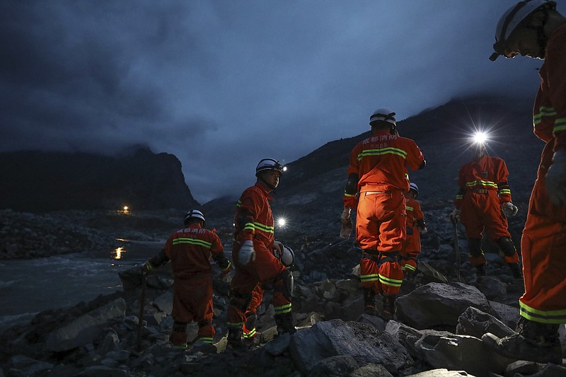 
              In this Saturday, June 24, 2017 photo released by China's Xinhua News Agency, rescuers work at the site of a landslide in Xinmo village in Maoxian County in southwestern China's Sichuan Province. Crews searching through the rubble left by a landslide that buried a mountain village under tons of soil and rocks in southwestern China on Saturday found bodies, but more than 100 people remained missing. (Jiang Hongjing/Xinhua via AP)
            