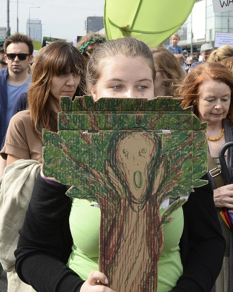 
              Protesters march demanding a stop to massive logging in the Bialowieza forest, one of Europe's last virgin woodlands, in Warsaw, Poland, Saturday, June 24, 2017.   The ruling Law and Justice party has allowed increased logging in Bialowieza, a vast woodland that straddles Poland and Belarus, alarming environmentalists who say it threatens a natural treasure.(AP Photo/Alik Keplicz)
            