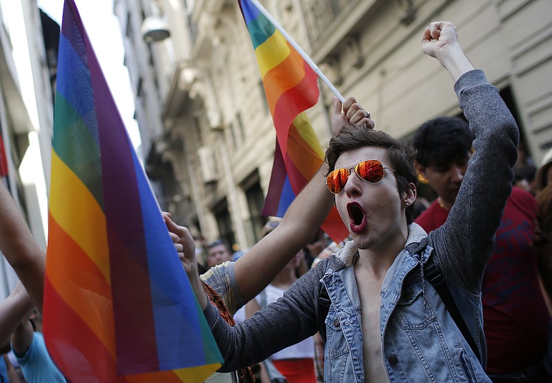 
              FILE - In this Sunday, June 28, 2015 file photo, participants of a Pride Week event in Istanbul, chant slogans after police used a water canon to disperse them. For several years, Pride Week in Istanbul attracted tens of thousands of participants, making it one of largest gatherings celebrating gay, lesbian and transgender rights and diversity in the Muslim world. That changed suddenly in 2015, when authorities, citing security concerns, banned gay and trans-gender pride events chasing away shocked participants trying to converge on central Taksim Square with tear gas and water cannons. (AP Photo/Emrah Gurel, File)
            