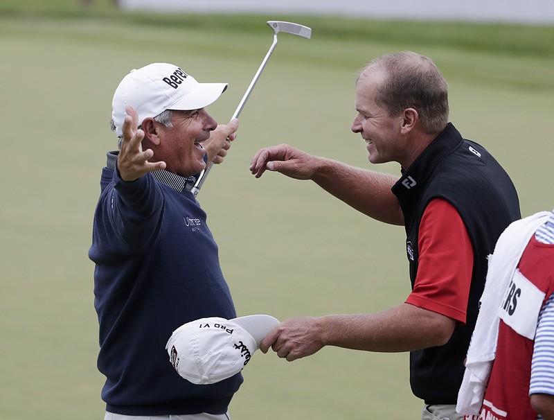 
              Fred Couples, left, hugs Steve Stricker, right, after making par on the 18th hole, and winning the American Family Insurance Championship held at University Ridge Golf Course Sunday, June 25, 2017 in Madison, Wis. (Steve Apps/Wisconsin State Journal via AP)
            