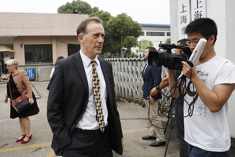 
              Australian Consul General Graeme Meehan, left,  arrives at the Baoshan District People's Court in Shanghai, China, Monday, June 26, 2017.  Australian and Chinese casino employees stood trial Monday on charges relating to gambling, which is illegal in mainland China, in a case that highlights the sensitivity of doing certain businesses in China. (AP Photo/Andy Wong)
            