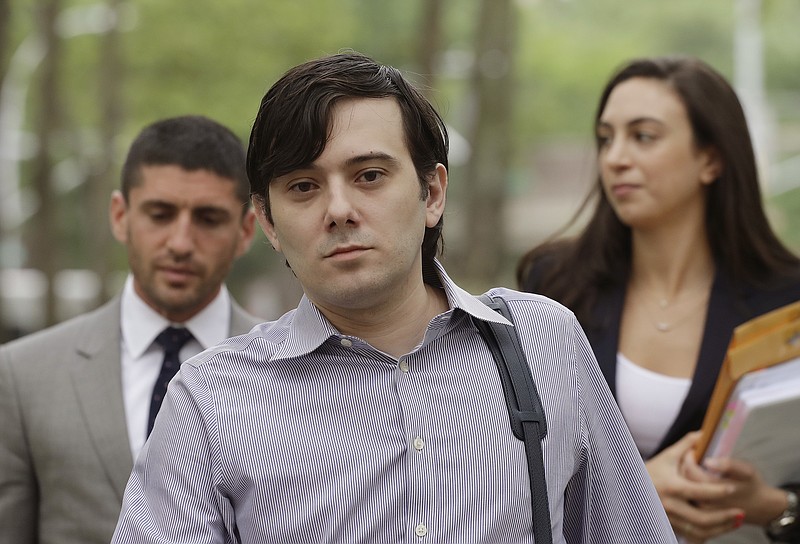 
              FILE - In this Monday, June 19, 2017, file photo, former Turing Pharmaceuticals CEO Martin Shkreli arrives at Brooklyn federal court with members of his legal team, in New York, for a pretrial conference in his securities fraud trial. Shkreli's trial begins Monday, June 26. (AP Photo/Mark Lennihan, File)
            