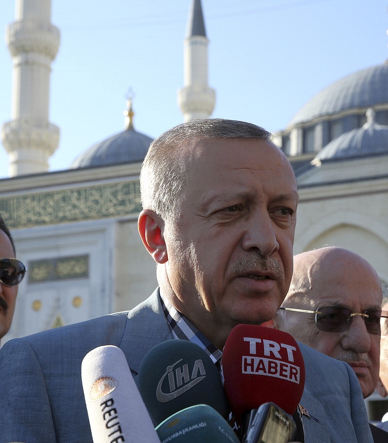 
              Turkey's President Recep Tayyip Erdogan speaks to the media after the Eid al-Fitr prayers in Istanbul, early Sunday, June 25, 2017. Eid al-Fitr marks the end of the Muslims' holy fasting month of Ramadan.(Presidential Press Service, Pool photo via AP)
            