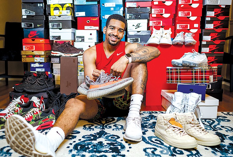 Jorden Williams with his collection of sneakers.