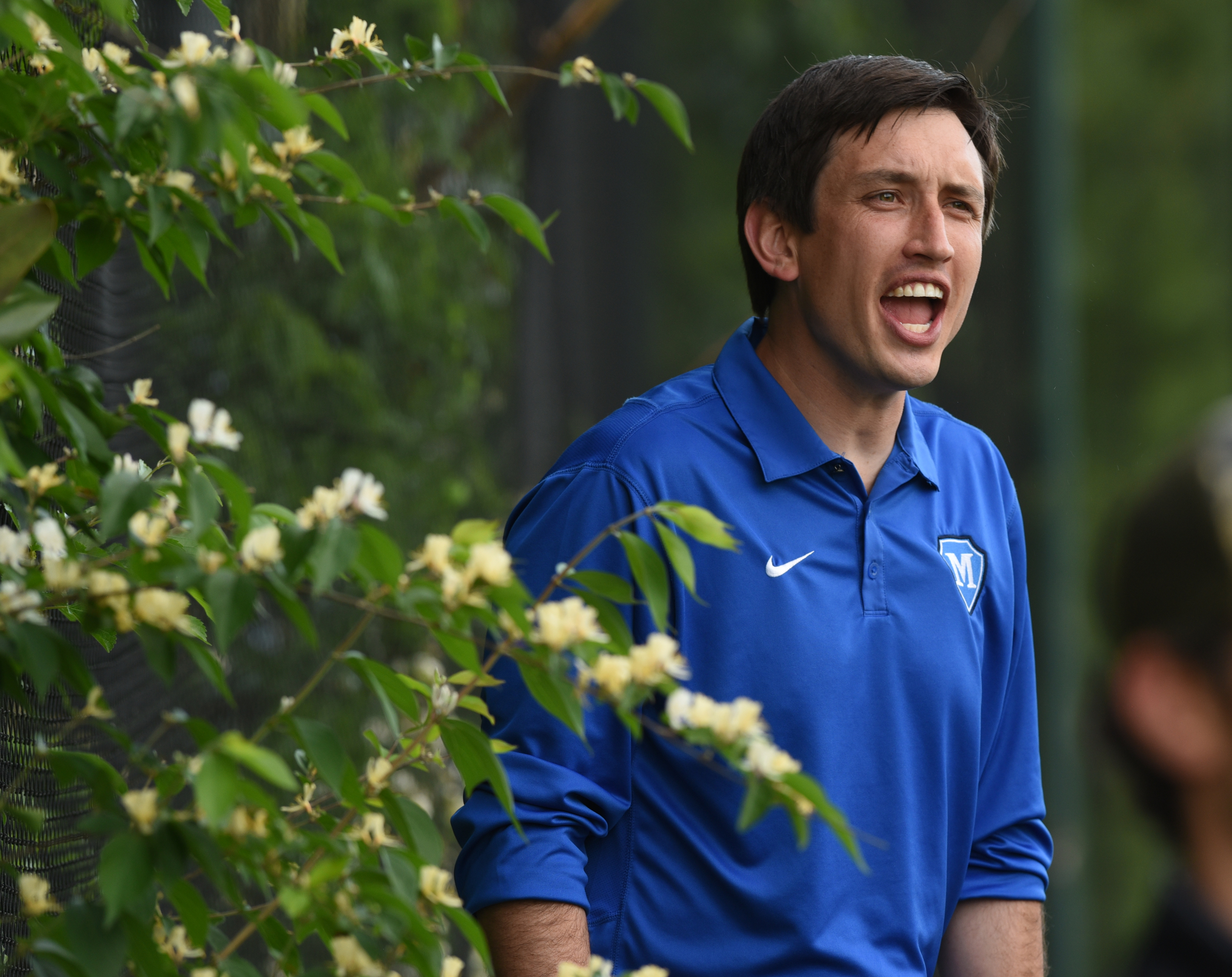 McCallie soccer coach Chris Cushenbery yells instructions standing atop a bench on the sideline Friday vs. Baylor.