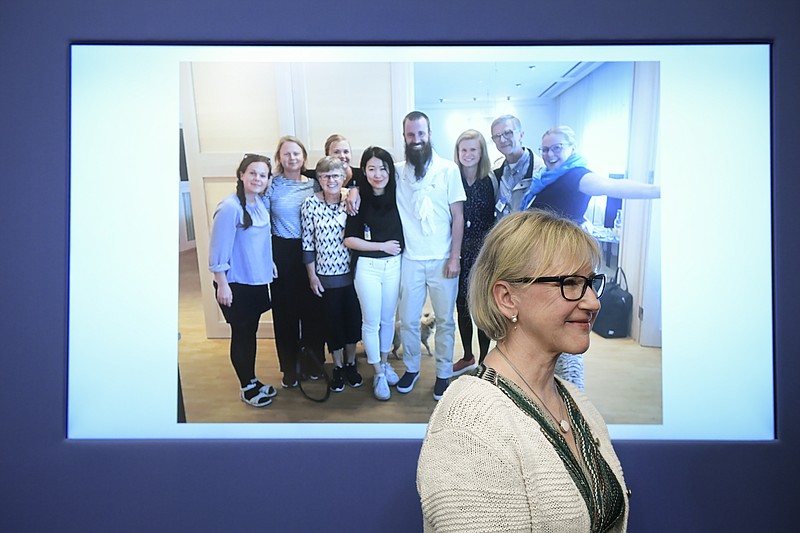 
              Swedish Foreign Minister, Margot Wallstrom, smiles in front of a picture of freed hostage Johan Gustafsson, centre, and his family at Arlanda airport after his arrival in Sweden on Monday afternoon, during a press conference about the release of Sweden's Johan Gustafsson who was kidnapped in Mali by al-Qaeda in the Islamic Maghreb (AQIM) in 2011, at the government headquarters in Stockholm, Sweden, Monday, June 26, 2017. Gustafsson was flown back to Sweden where he arrived Monday afternoon. (Marcus Ericsson /TT via AP)
            