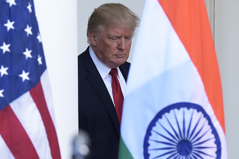 
              President Donald Trump walks out from the Oval Office to make a joint statement with Indian Prime Minister Narendra Modi in the Rose Garden of the White House in Washington, Monday, June 26, 2017. (AP Photo/Susan Walsh)
            