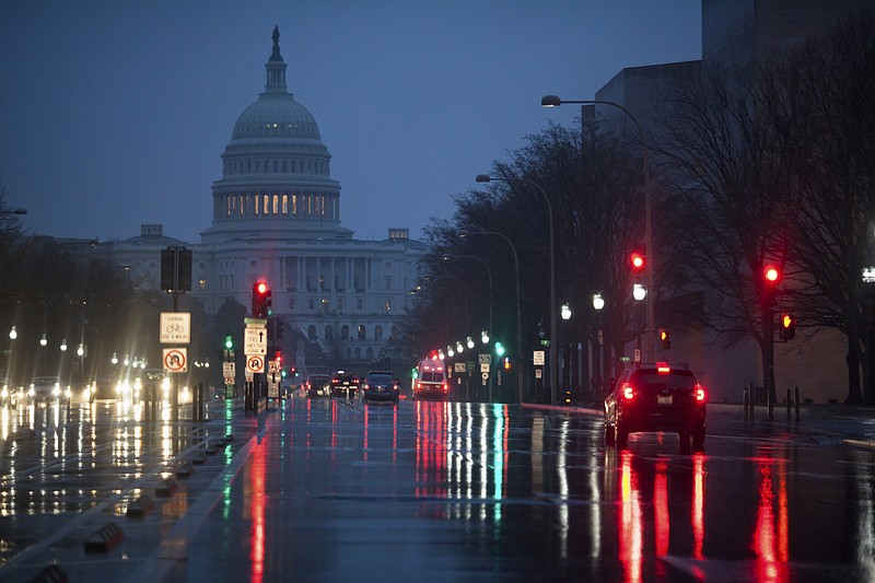 
              FILE - In this March 31, 2017, file photo, The U.S. Capitol is seen in the distance as rain falls on Pennsylvania Avenue in Washington. Why are Republicans struggling mightily to reach a consensus on how to overhaul the nation’s tax system? The GOP is supposed to be really good at cutting taxes. (AP Photo/J. Scott Applewhite, file)
            