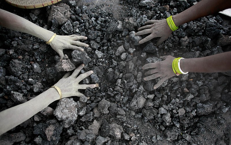 
              FILE - In this Monday, Dec. 14, 2015, file photo, Indian women use bare hands to pick reusable pieces from heaps of used coal discarded by a carbon factory in Gauhati, India. The world’s biggest coal users - China, the United States and India - have boosted coal mining in 2017, in an abrupt departure from last year’s record global decline for the heavily polluting fuel and a setback to efforts to rein in climate change emissions. (AP Photo/ Anupam Nath, File)
            