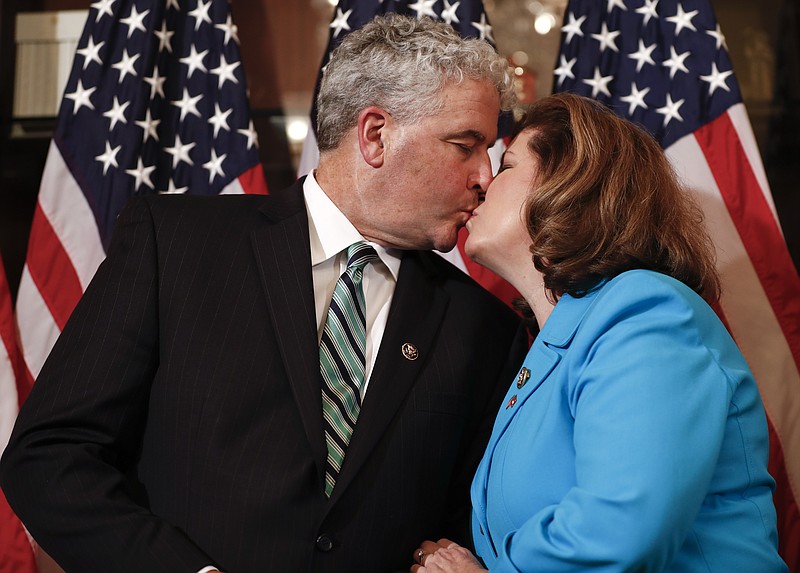 
              Representative-elect Karen Handel, R-Ga., right, kisses her husband Steve Handel before a ceremonial swearing-in on Capitol Hill in Washington, Monday, June 26, 2017. Handel, the Republican winner of the most expensive House race ever, is preparing to take her seat representing Atlanta's outskirts, along with a South Carolina Republican who claimed a narrower-than-expected victory to retain a strongly Republican seat. (AP Photo/Carolyn Kaster)
            