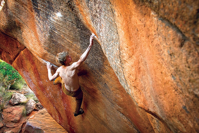 McCallie student Nathan Williams reaches for a small hold on El Corazon, a boulder in South Africa's Docklands. 