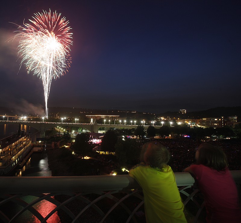 People watch the fireworks finale of a previous Pops on the River concert. Pops on the River will be held Monday, July 3, in Coolidge Park with a fireworks display following the concert.