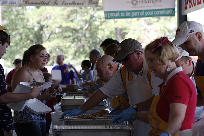 Signal Mountain residents line up to be served at a previous July Fourth barbecue in Althaus Park.