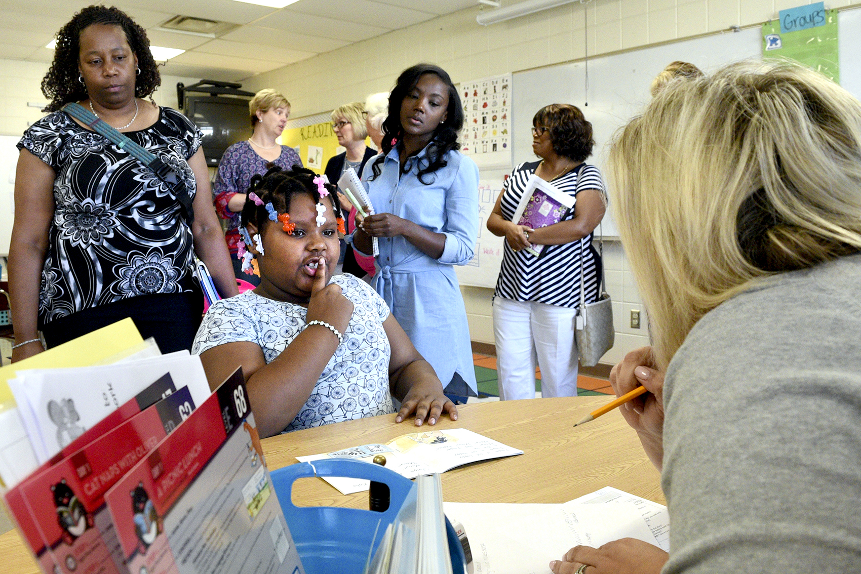 Katie Hamby, Literacy Coach with Barger Academy/Bess T. Shepherd schools, works with Hardy Hope participant Markayla McGhee as Hamilton County elementary principals observe. Hamilton County's elementary principals gathered at Hardy Elementary to learn new tips for boosting literacy throughout their schools on June 27, 2017.
