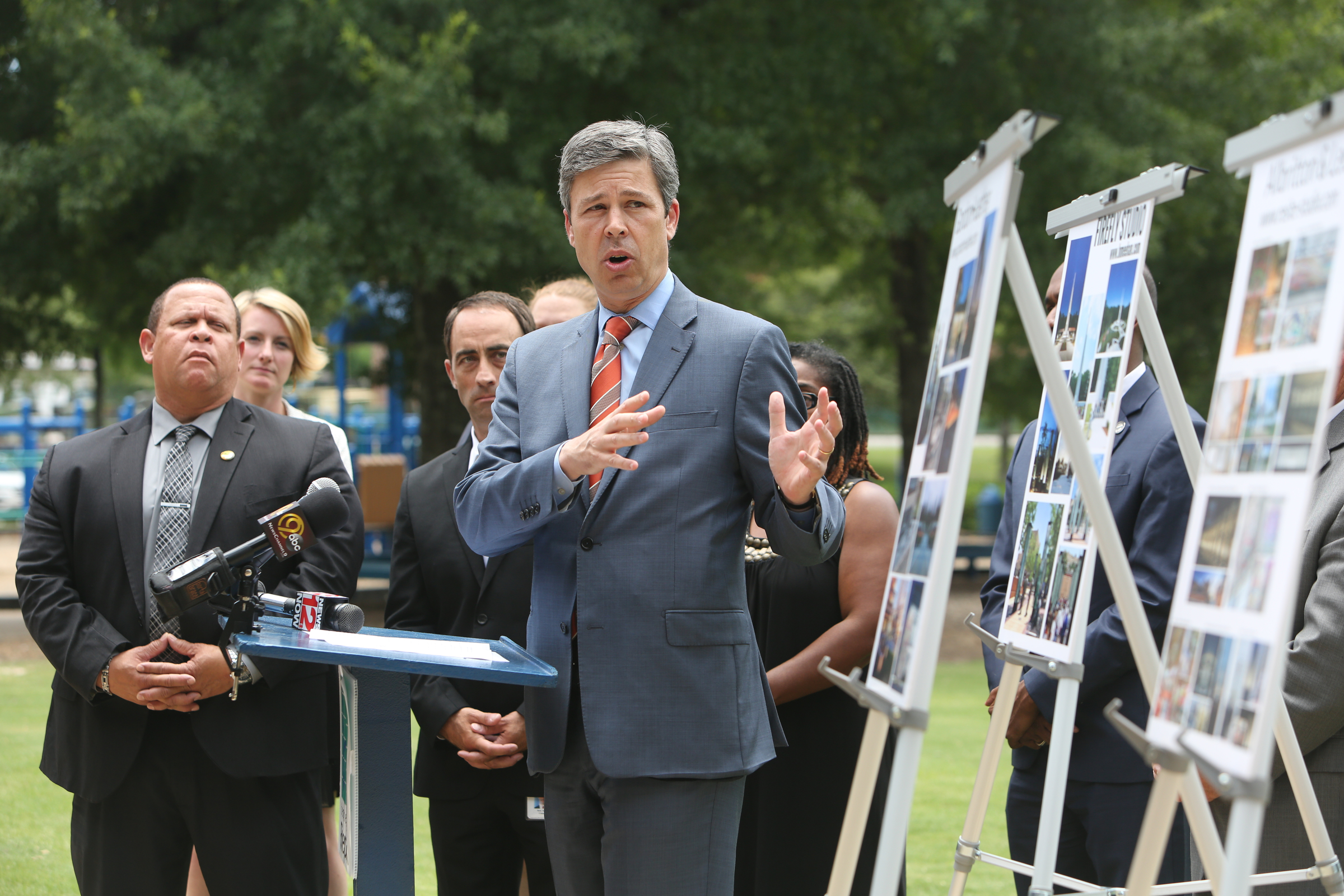 During a press conference at the at the Hubert Fry Center Pavilion in Chattanooga, Tenn., Chattanooga Mayor Andy Berke points to the work of three artists chosen as semifinalists for creating the permanent memorial honoring the five servicemen who were killed in a domestic terror attack on July 16, 2015, that will be installed along the Tennessee Riverwalk. Gordon Huether with Gates and Associates, Shane Allbritton and Norman Lee of Re:site, and Howard Meehan and William Freer of Firefly Studio will offer proposals in September, and by the end of the year one will be selected.