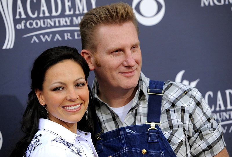 
              FILE - In this April 3, 2011, file photo, Joey Feek, left, and her husband Rory Feek, of "Joey + Rory," arrive at the Annual Academy of Country Music Awards in Las Vegas. Rory Feek  announced he will perform publicly for the first time since his wife Joey died last year to raise funds for the Music Health Alliance, a nonprofit that helped his family with insurance and medical bills. (AP Photo/Chris Pizzello, File)
            