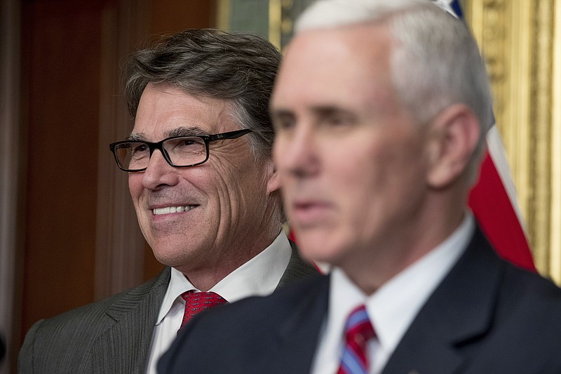 
              FILE- In this March 2, 2017, file photo, Vice President Mike Pence, right, speaks before administering the oath of office to Energy Secretary Rick Perry, left, in the Eisenhower Executive Office Building on the White House complex in Washington. Perry said Monday, June 26, that the Trump administration is confident officials can "pave the path toward U.S. energy dominance" by exporting oil, gas and coal to markets around the world, and promoting nuclear energy and even renewables such as wind and solar power. (AP Photo/Andrew Harnik, File)
            