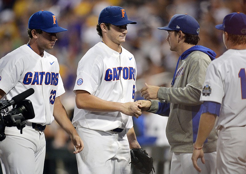 
              Florida pitcher Tyler Dyson, center, is congratulated by teammates after being relieved during the seventh inning against LSU in Game 2 of the NCAA College World Series baseball finals in Omaha, Neb., Tuesday, June 27, 2017. (AP Photo/Matt Ryerson)
            