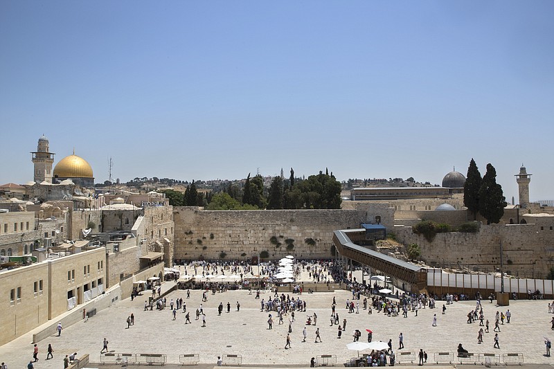 
              Visitors are seen at the Western Wall, the holiest site where Jews can pray in Jerusalem's Old City, Monday, June 26, 2017. A high-profile group of Jewish leaders cancelled a gala event with Prime Minister Benjamin Netanyahu on Monday to protest his government's decision to scrap plans for a mixed-gender prayer area at Jerusalem's Western Wall. (AP Photo/Sebastian Scheiner)
            