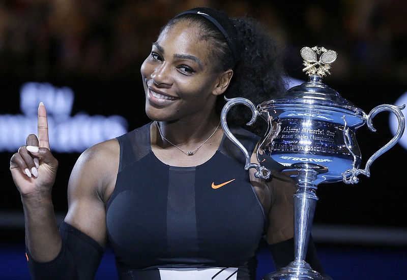 
              FILE - In this Jan. 28, 2017, file photo, Serena Williams holds up a finger and her trophy after defeating her sister, Venus, in the women's singles final at the Australian Open tennis championships in Melbourne, Australia. Williams posed nude for the cover of Vanity Fair in an image released by the magazine on June 27, 2017. (AP Photo/Aaron Favila, File)
            