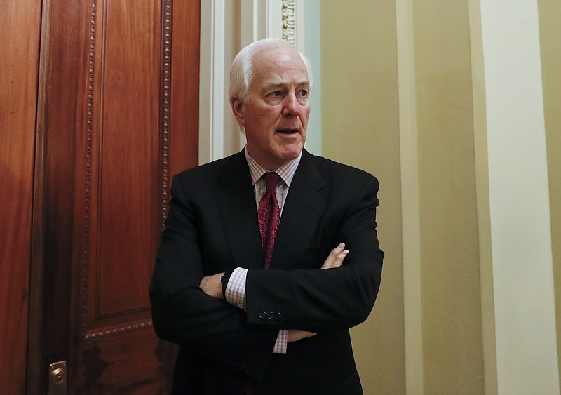 
              Senate Majority Whip John Cornyn of Texas, pauses as he speaks to reporters outside his office on Capitol Hill in Washington, Monday, June 26, 2017. Senate Republicans unveil a revised health care bill in hopes of securing support from wavering GOP lawmakers, including one who calls the drive to whip his party's bill through the Senate this week "a little offensive." (AP Photo/Carolyn Kaster)
            