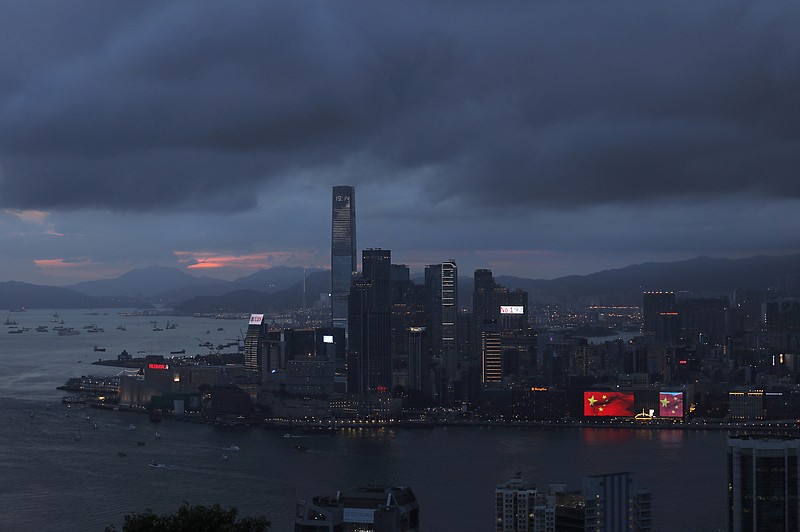 
              In this June 24, 2017 photo, an electronic monitor shows the China national flags outside a shopping center in Hong Kong to mark the 20th anniversary of Hong Kong handover to China. Hong Kong is planning a big party as it marks 20 years under Chinese rule. But many people in the former British colony are not in the mood to celebrate. (AP Photo/Vincent Yu)
            