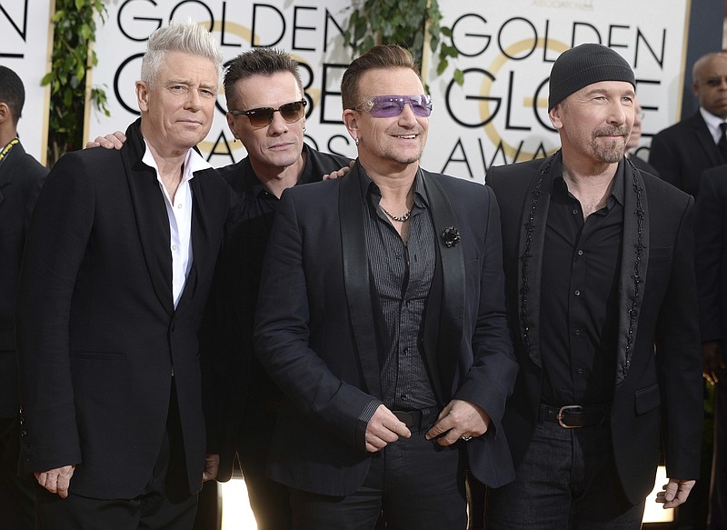 
              FILE - This Jan. 12, 2014 file photo shows members of the Irish rock band U2, from left, Adam Clayton, Larry Mullen, Jr., Bono, and The Edge at the 71st annual Golden Globe Awards at the Beverly Hilton Hotel in Beverly Hills, Calif. Clayton thanked his bandmates on Monday, June 26, 2017, for their support during his treatment and recovery from alcohol abuse years ago, before joining them for a rollicking rendition of a few hits. Clayton received an award Monday at a Manhattan theater from MusiCares, a foundation that helps musicians get treatment for addiction. (Photo by Jordan Strauss/Invision/AP, File)
            