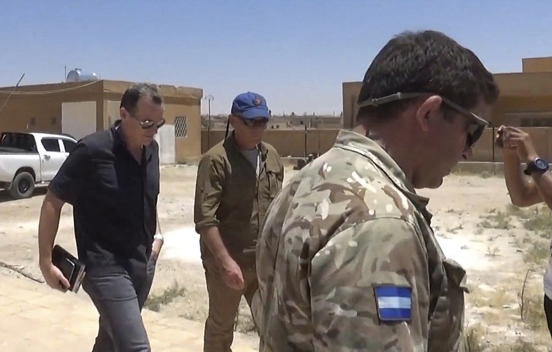 
              This frame grab from video released Wednesday June 28, 2017, by ANHA news agency for the semi-autonomous Kurdish areas in Syria, that is consistent with independent AP reporting, shows Brett McGurk, left, the top U.S. envoy for the international coalition combatting the Islamic State group, leaving after a visit to  Ayn Issa, Syria. McGurk met with members of a local council expected to administer the city of Raqqa in Syria following its capture from the militants. (ANHA News Agency, via AP)
            