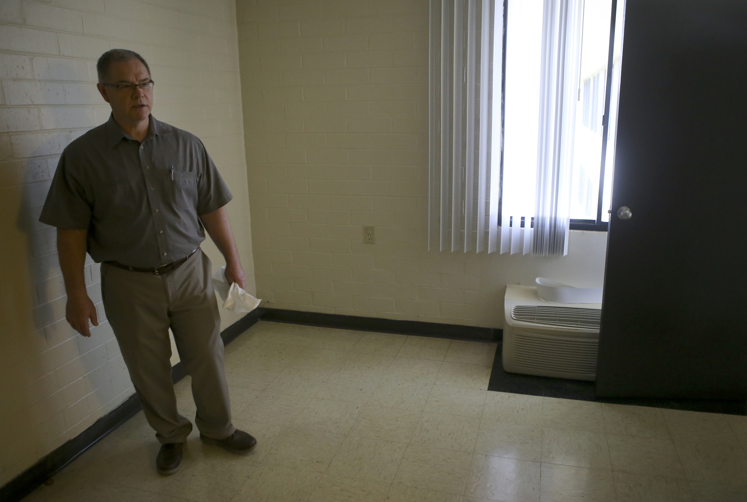 Lonnie Edwards, the project manager for the renovation of Boynton Terrace Apartments, leads a tour of the non-renovated units on Wednesday, June 28, in Chattanooga, Tenn.