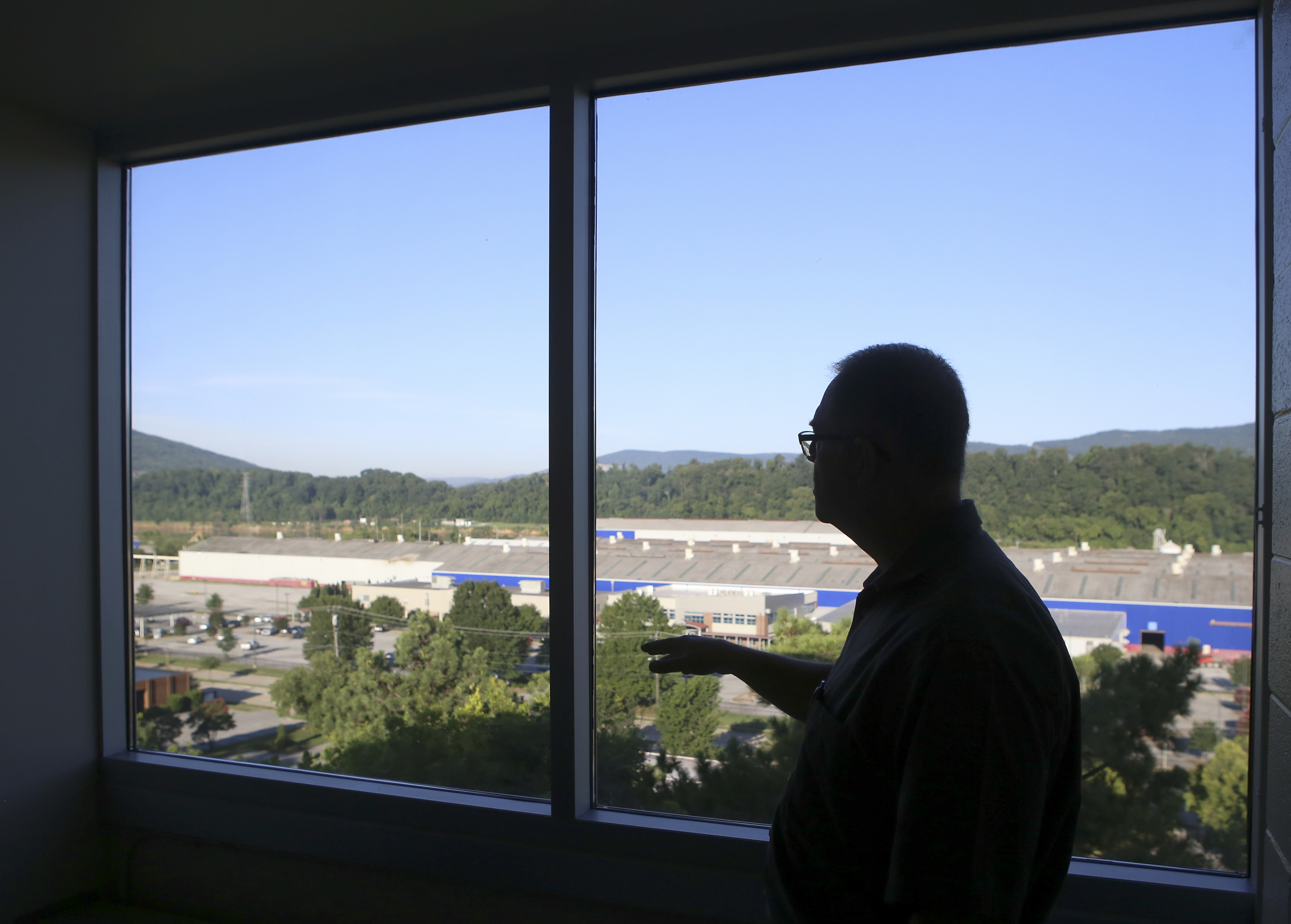 Lonnie Edwards, the project manager for the renovation of Boynton Terrace Apartments, leads a tour of one of the units on Wednesday, June 28, in Chattanooga, Tenn.