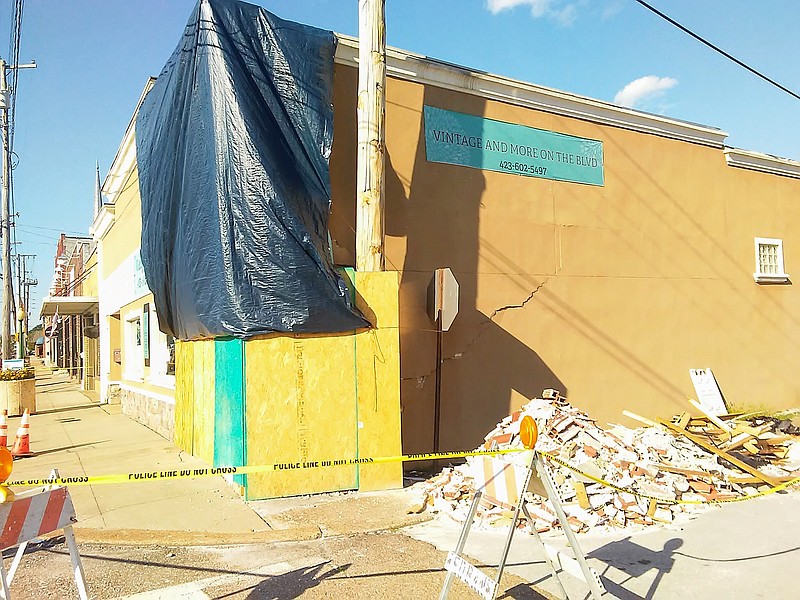 A pile of bricks and yellow caution tape outside Vintage and More on the Blvd. Tuesday is a reminder of the June 8 accident when a sport-utility vehicle crashed through the exterior brick wall.