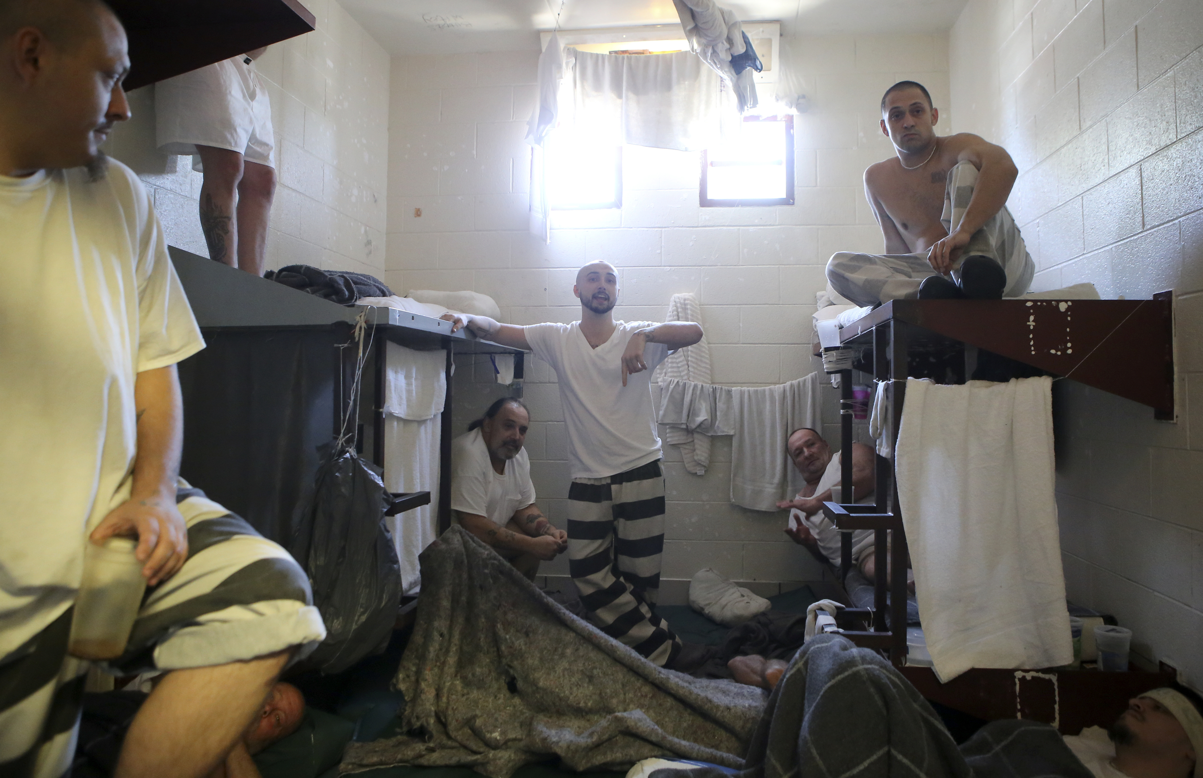 Jesse Lynn Wyatt, center, speaks while a tour is given to show the overcrowding at the Rhea County Jail on Wednesday, June 28, in Dayton, Tenn. Wyatt shares a four-bed cell with ten other inmates.