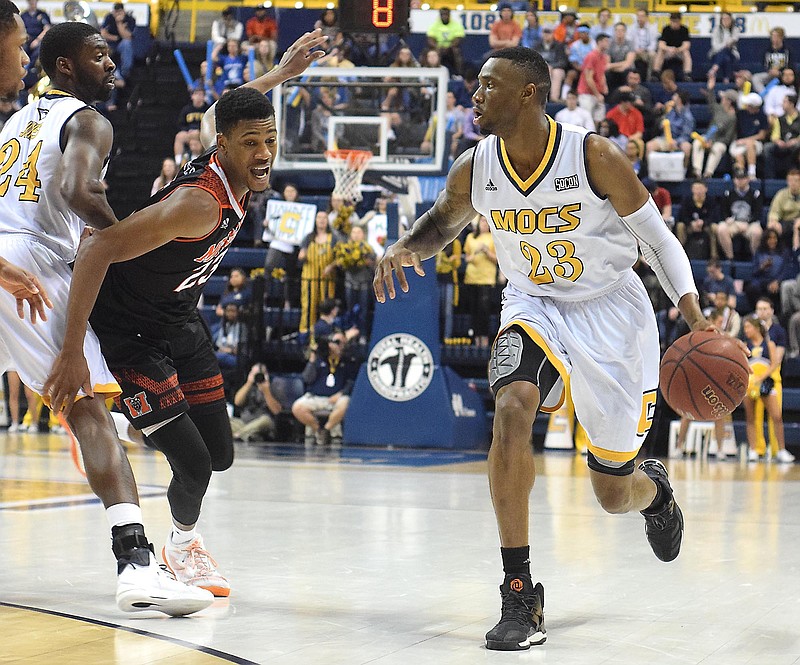 UTC's Tre' McLean (23) dribbles around the pick of teammate Casey Jones (24).  The Mercer Bears Chattanooga Mocs in Southern Conference Basketball action at McKenzie Arena on February 25, 2017.