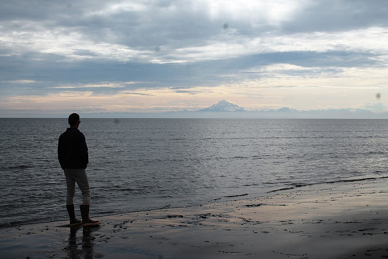 Two sights that let you know you're in Alaska: big mountains — seen from the beach of the Kai Peninsula — and a pair of Xtratuff rubber boots, the go-to footwear of choice for summer in the 49th state.