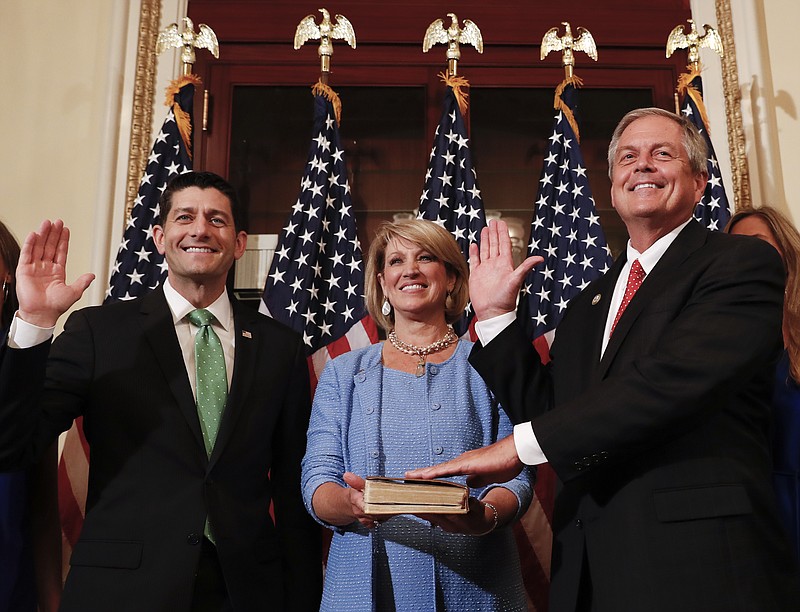 Speaker of the House Paul Ryan, R-Wis., left, Representative-elect Ralph Norman, R-S.C., right and his wife Elaine Rice Norman, center, participate in a ceremonial swearing-in on Capitol Hill in Washington, Monday, June 26, 2017. Norman, a staunch conservative, had a 3 percentage point victory last week in a South Carolina race in a district that went for President Donald Trump last year by 18 percentage points. (AP Photo/Carolyn Kaster)
