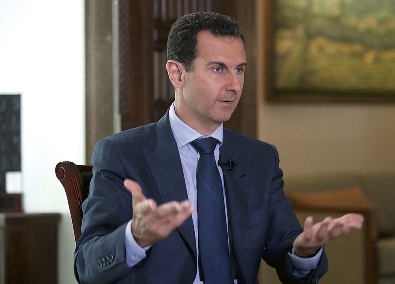In this Wednesday, Sept. 21, 2016 file photo released by the Syrian Presidency, Syrian President Bashar Assad speaks to The Associated Press at the presidential palace in Damascus, Syria. The Syrian government on Tuesday, June 27, 2017 dismissed White House allegations that it was preparing a new chemical weapons attack, as activists reported an airstrike on an Islamic State-run jail in eastern Syria that they said killed more than 40 prisoners. (Syrian Presidency via AP, File)